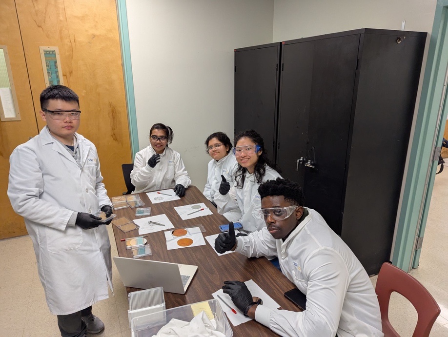 Students showing wafer coupons during an SJSU microfabrication workshop